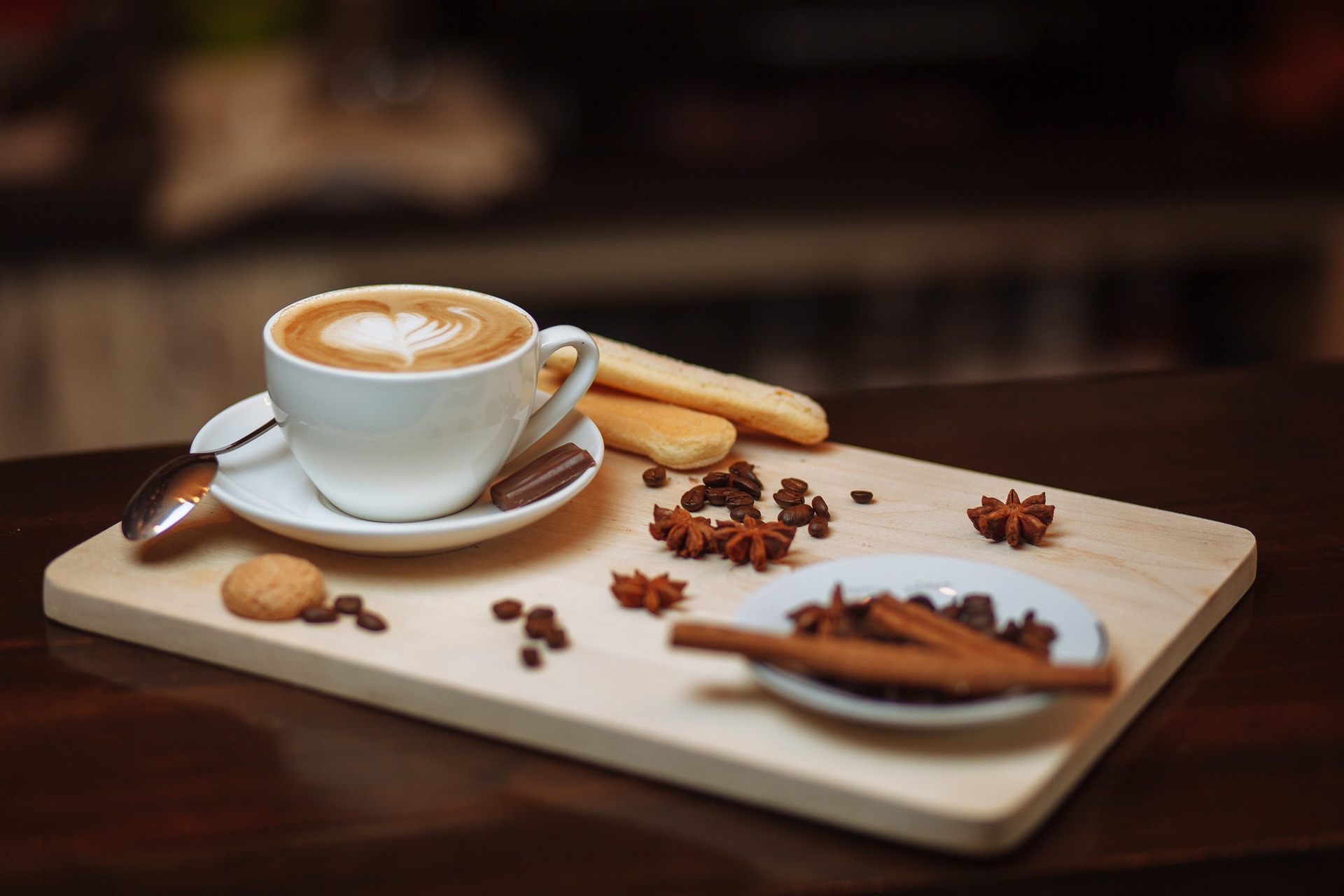 A luxurious assortment of high-quality coffee ingredients spread out on a wooden board